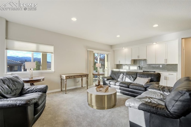 2062 Lone Willow Vw, Colorado Springs, CO 80904 - living area with light colored carpet, baseboards, and recessed lighting