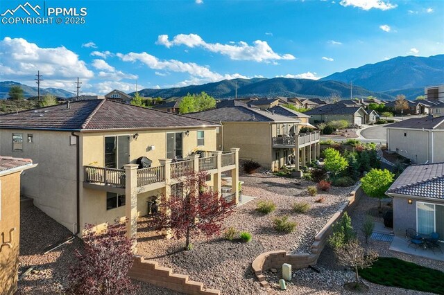 2062 Lone Willow Vw, Colorado Springs, CO 80904 - rear view of house featuring a mountain view, a residential view, and stucco siding