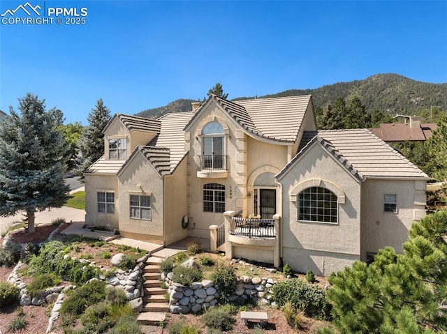 1360 Chartwell Vw, Colorado Springs, CO 80906 - back of property with stucco siding, a tiled roof, and a balcony