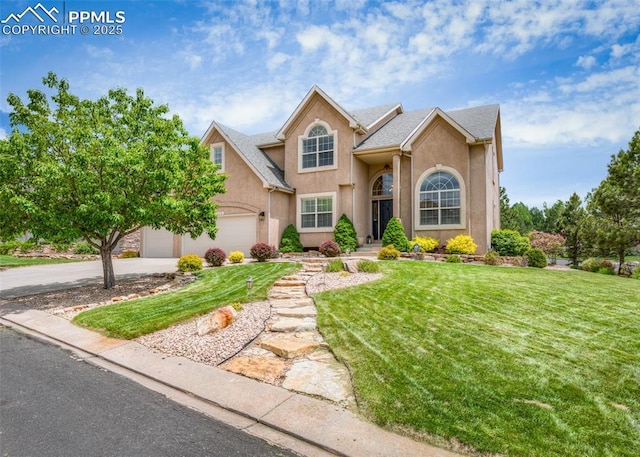 12515 Broad Oaks Dr, Colorado Springs, CO 80921 - traditional-style house with driveway, a front yard, stucco siding, and a garage