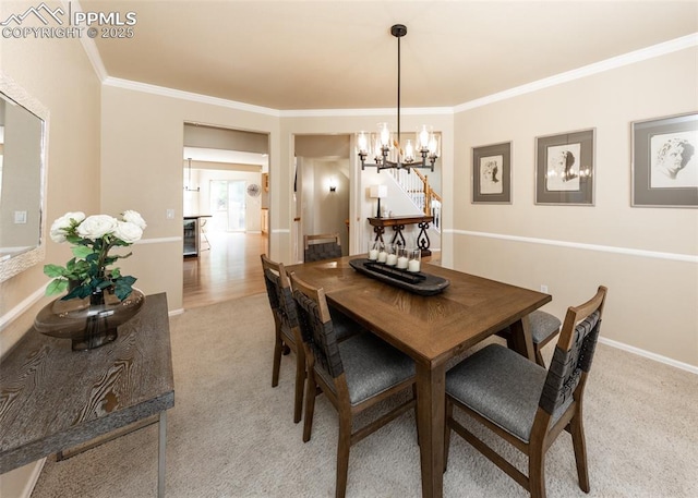 12515 Broad Oaks Dr, Colorado Springs, CO 80921 - dining space with ornamental molding, a chandelier, light carpet, and baseboards