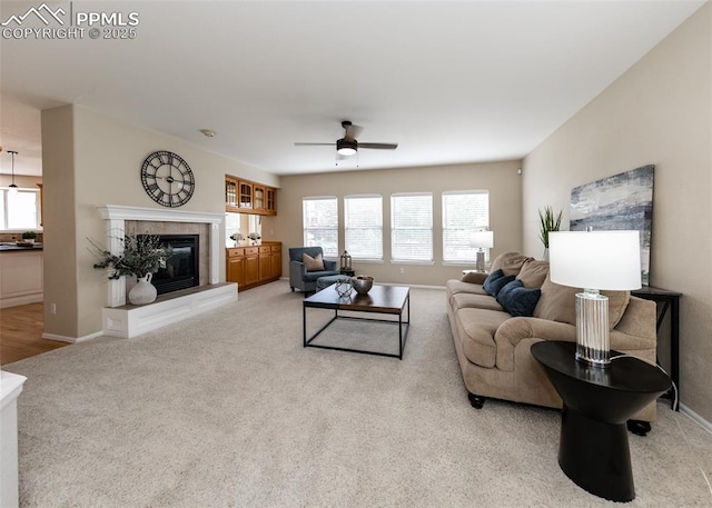 12515 Broad Oaks Dr, Colorado Springs, CO 80921 - living room featuring a tile fireplace, a ceiling fan, light colored carpet, and baseboards