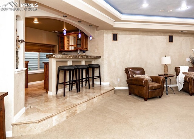 12515 Broad Oaks Dr, Colorado Springs, CO 80921 - indoor bar featuring baseboards, ornamental molding, light colored carpet, hanging light fixtures, and a raised ceiling