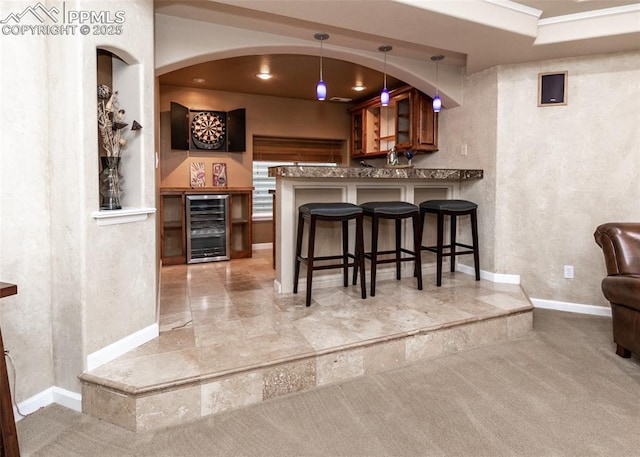 12515 Broad Oaks Dr, Colorado Springs, CO 80921 - indoor wet bar featuring beverage cooler, carpet flooring, baseboards, and decorative light fixtures