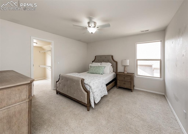 12515 Broad Oaks Dr, Colorado Springs, CO 80921 - bedroom with light carpet, a spacious closet, ceiling fan, and baseboards