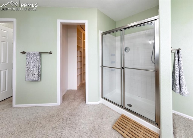 12515 Broad Oaks Dr, Colorado Springs, CO 80921 - bathroom with tiled shower, baseboards, carpet floors, and a walk in closet