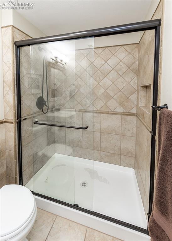 12515 Broad Oaks Dr, Colorado Springs, CO 80921 - full bath with toilet, a stall shower, and tile patterned flooring