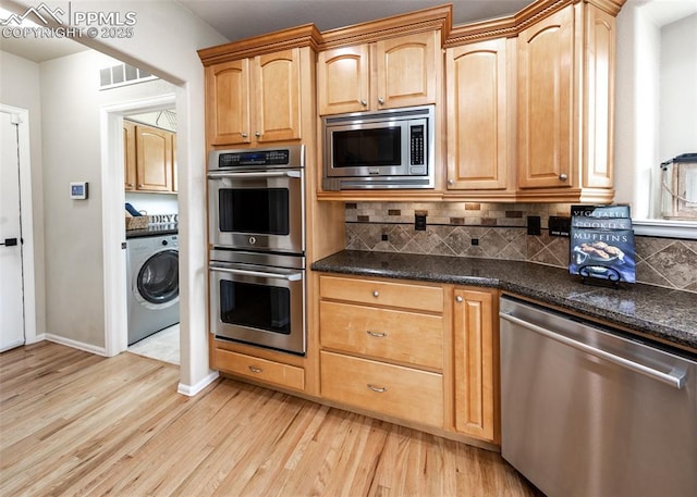 12515 Broad Oaks Dr, Colorado Springs, CO 80921 - kitchen featuring stainless steel appliances, washer / clothes dryer, light wood-style flooring, tasteful backsplash, and baseboards