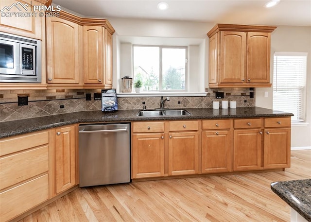 12515 Broad Oaks Dr, Colorado Springs, CO 80921 - kitchen with appliances with stainless steel finishes, a sink, light wood-type flooring, tasteful backsplash, and recessed lighting