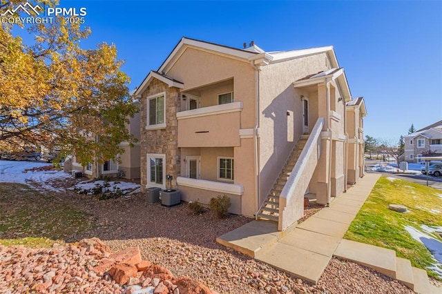 3735 Strawberry Field Grv Unit B, Colorado Springs, CO 80906 - view of property featuring stairway and central AC