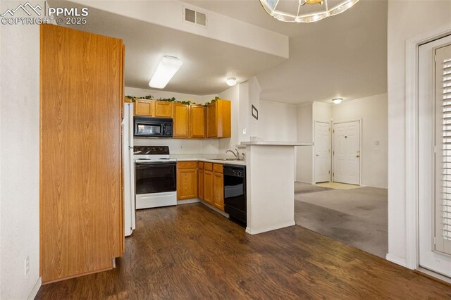 3735 Strawberry Field Grv Unit B, Colorado Springs, CO 80906 - kitchen featuring black appliances, dark wood-style flooring, light countertops, a peninsula, and a sink