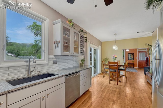 115 N 24th St, Colorado Springs, CO 80904 - kitchen featuring appliances with stainless steel finishes, a sink, tasteful backsplash, and ceiling fan