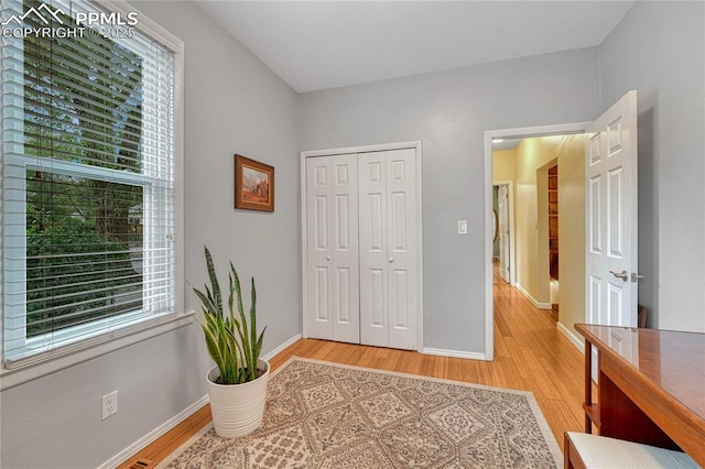 115 N 24th St, Colorado Springs, CO 80904 - bedroom featuring multiple windows, light wood finished floors, and baseboards