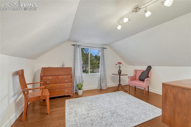 115 N 24th St, Colorado Springs, CO 80904 - living area featuring vaulted ceiling, wood finished floors, baseboards, and a textured ceiling