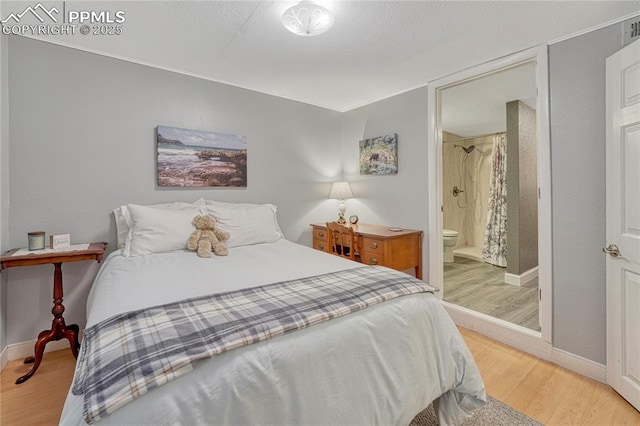 115 N 24th St, Colorado Springs, CO 80904 - bedroom with light wood-style floors, baseboards, and connected bathroom