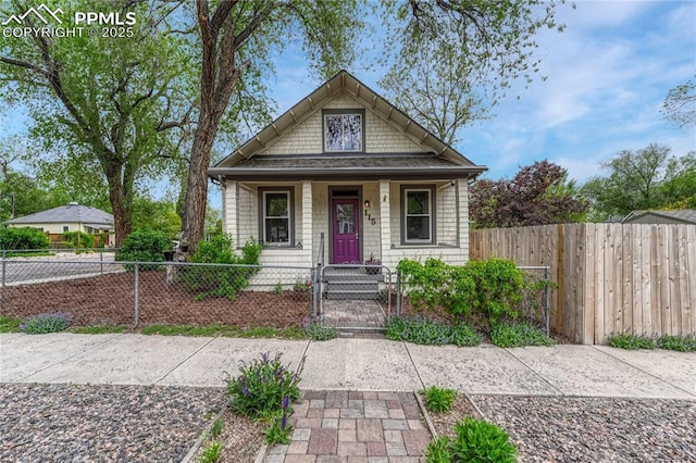115 N 24th St, Colorado Springs, CO 80904 - bungalow featuring a gate, a porch, and a fenced front yard