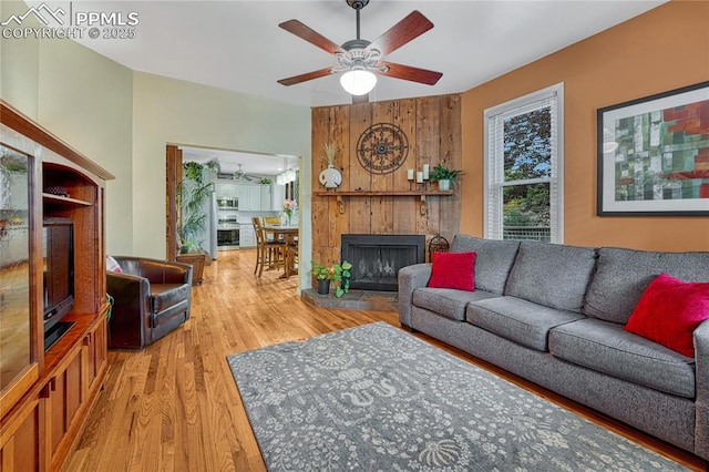 115 N 24th St, Colorado Springs, CO 80904 - living area with wood finished floors, ceiling fan, and a fireplace with raised hearth