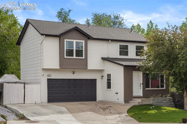 view of front of home with an attached garage, concrete driveway, and roof with shingles