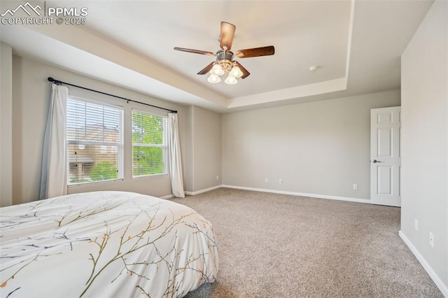 8445 Jacks Fork Dr, Colorado Springs, CO 80924 - bedroom featuring carpet, baseboards, a raised ceiling, and a ceiling fan
