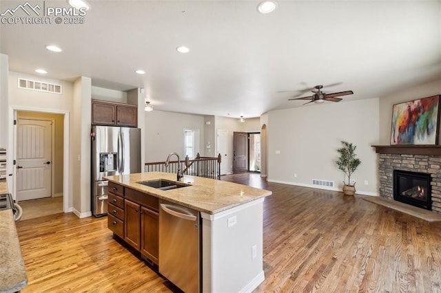 7663 Double Barrel Hts, Colorado Springs, CO 80923 - kitchen featuring stainless steel appliances, a sink, a ceiling fan, light wood finished floors, and recessed lighting