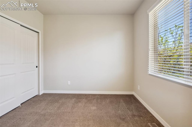 7663 Double Barrel Hts, Colorado Springs, CO 80923 - unfurnished bedroom featuring carpet, multiple windows, baseboards, and a closet