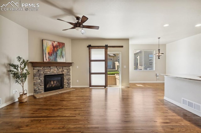 7663 Double Barrel Hts, Colorado Springs, CO 80923 - unfurnished living room with wood finished floors, baseboards, ceiling fan, a stone fireplace, and recessed lighting