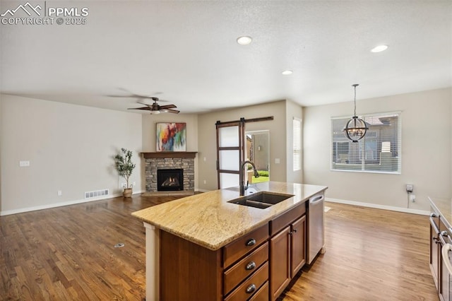 7663 Double Barrel Hts, Colorado Springs, CO 80923 - kitchen with stainless steel dishwasher, a sink, wood finished floors, ceiling fan, and recessed lighting