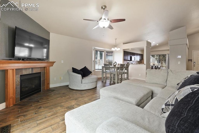 7719 Paca Pl, Fountain, CO 80817 - living area featuring wood finished floors, ceiling fan, plenty of natural light, and vaulted ceiling