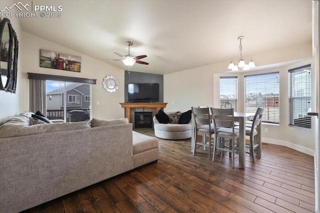 7719 Paca Pl, Fountain, CO 80817 - living room with plenty of natural light, dark wood finished floors, a chandelier, lofted ceiling, and a ceiling fan