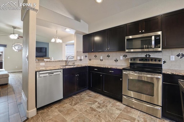 7719 Paca Pl, Fountain, CO 80817 - kitchen with stainless steel appliances, a sink, lofted ceiling, a ceiling fan, and tasteful backsplash