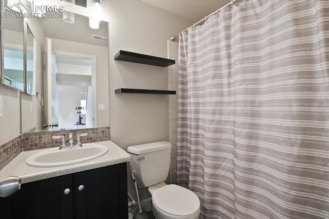 7719 Paca Pl, Fountain, CO 80817 - full bath featuring a textured wall, backsplash, toilet, vanity, and a shower with curtain