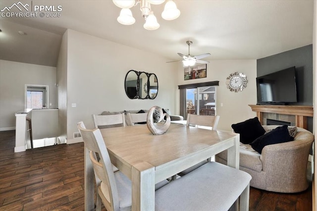 7719 Paca Pl, Fountain, CO 80817 - dining area with dark wood finished floors, a chandelier, ceiling fan, and baseboards
