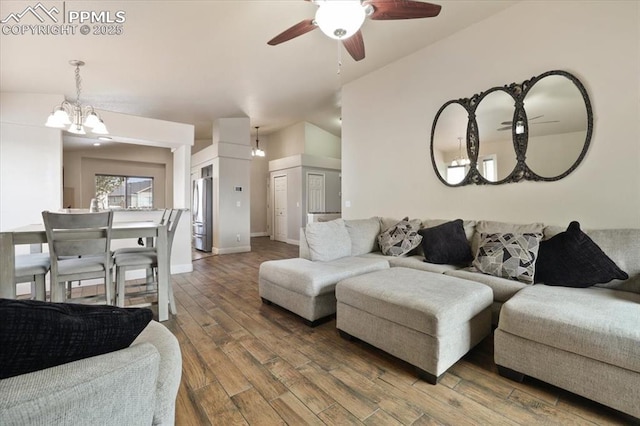 7719 Paca Pl, Fountain, CO 80817 - living room with a chandelier, a ceiling fan, wood finished floors, and baseboards