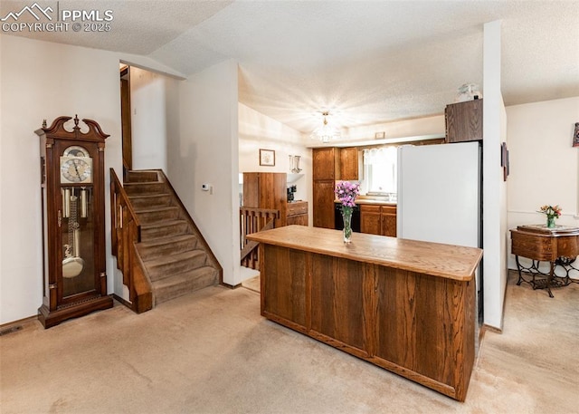15335 Deby Dr, Colorado Springs, CO 80921 - kitchen featuring light carpet, light countertops, a textured ceiling, brown cabinets, and vaulted ceiling