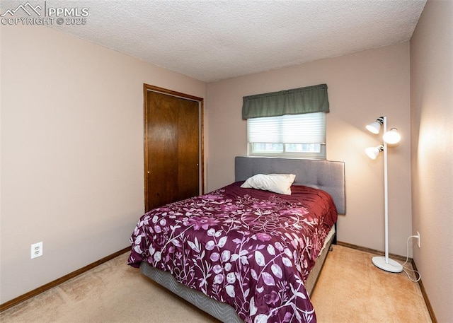 15335 Deby Dr, Colorado Springs, CO 80921 - bedroom featuring carpet flooring, a closet, baseboards, and a textured ceiling