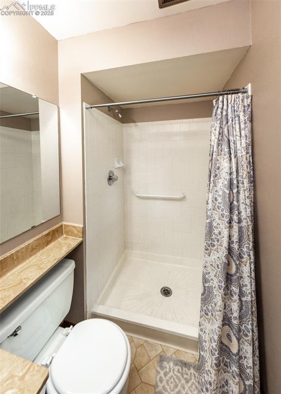 15335 Deby Dr, Colorado Springs, CO 80921 - bathroom featuring toilet, a stall shower, and tile patterned flooring