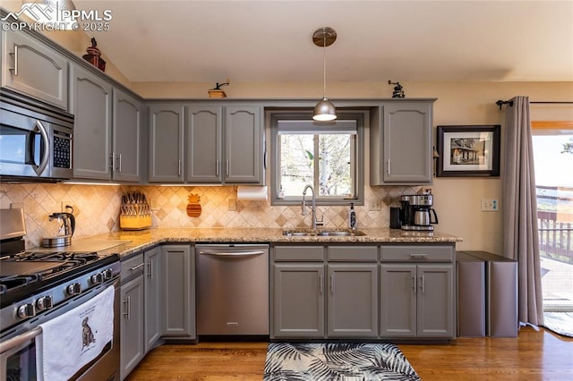 1053 Kings Crown Rd, Woodland Park, CO 80863 - kitchen with appliances with stainless steel finishes, a sink, gray cabinets, and light stone countertops