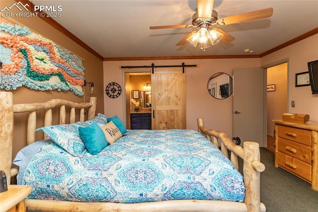 1053 Kings Crown Rd, Woodland Park, CO 80863 - carpeted bedroom featuring a barn door, crown molding, connected bathroom, and a ceiling fan