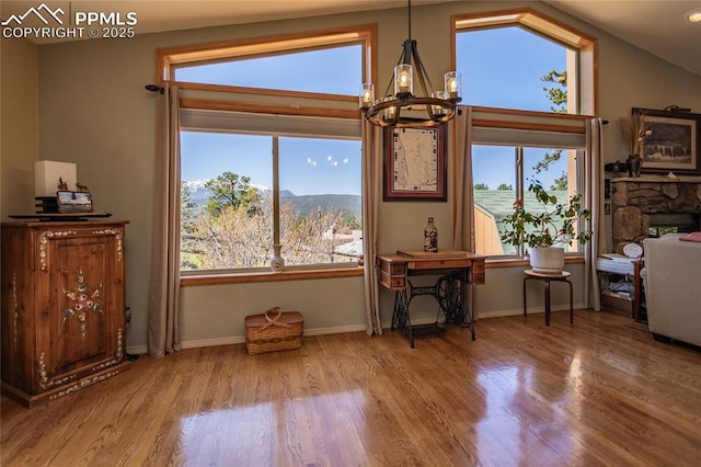 1053 Kings Crown Rd, Woodland Park, CO 80863 - dining area with a chandelier, wood finished floors, lofted ceiling, and baseboards