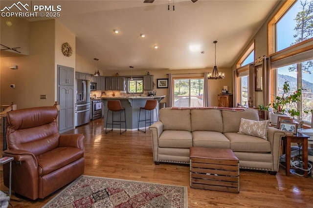 1053 Kings Crown Rd, Woodland Park, CO 80863 - living area featuring high vaulted ceiling, dark wood-style flooring, a chandelier, a ceiling fan, and recessed lighting