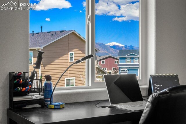 7568 Benecia Dr, Fountain, CO 80817 - office area with healthy amount of natural light, a textured wall, and a mountain view