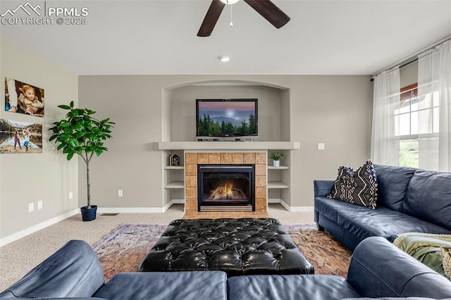 9883 Red Sage Dr, Colorado Springs, CO 80920 - living area featuring carpet flooring, baseboards, ceiling fan, and a fireplace