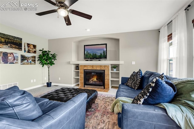 9883 Red Sage Dr, Colorado Springs, CO 80920 - carpeted living area featuring ceiling fan, baseboards, and a fireplace