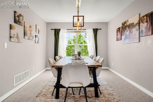 9883 Red Sage Dr, Colorado Springs, CO 80920 - carpeted dining room featuring a chandelier, baseboards, and a textured wall