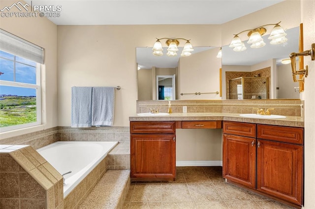 9883 Red Sage Dr, Colorado Springs, CO 80920 - bathroom featuring double vanity, a chandelier, a bath, and a stall shower