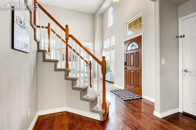 9883 Red Sage Dr, Colorado Springs, CO 80920 - entryway featuring wood finished floors, stairs, and baseboards