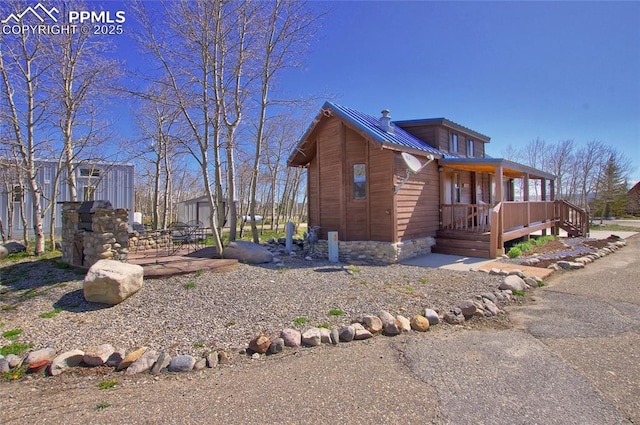 65 Sunshine Loop, Fairplay, CO 80440 - view of side of home with metal roof and a wooden deck