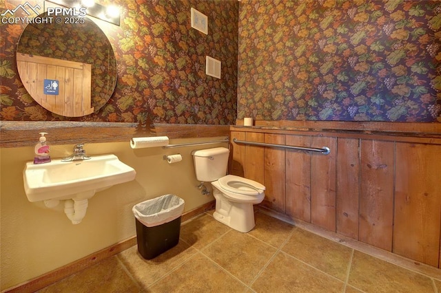 65 Sunshine Loop, Fairplay, CO 80440 - half bath featuring wallpapered walls, a wainscoted wall, toilet, tile patterned flooring, and a sink
