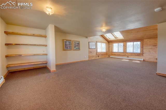 65 Sunshine Loop, Fairplay, CO 80440 - additional living space with a baseboard radiator, wooden walls, vaulted ceiling, carpet flooring, and a skylight