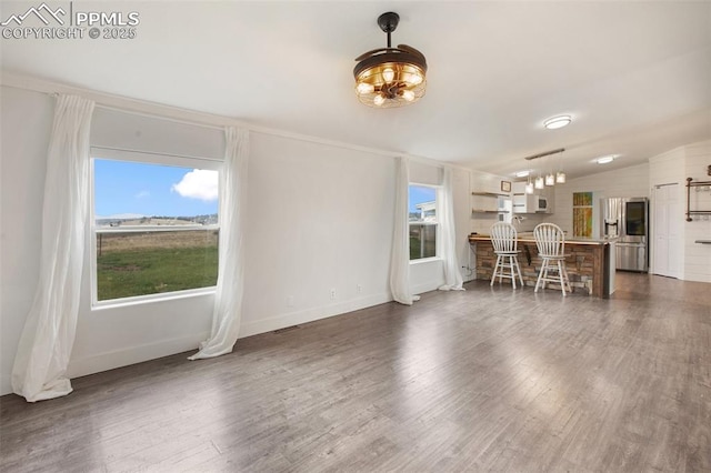 527 Golden Grain Ln, Divide, CO 80814 - living area with healthy amount of natural light, dark wood finished floors, a chandelier, baseboards, and vaulted ceiling